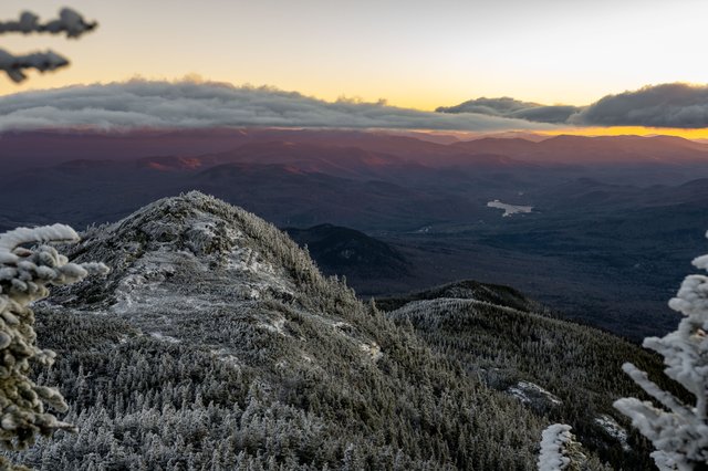 Fiery sunset casting orange hues over the Third Howk’s summit rocks.